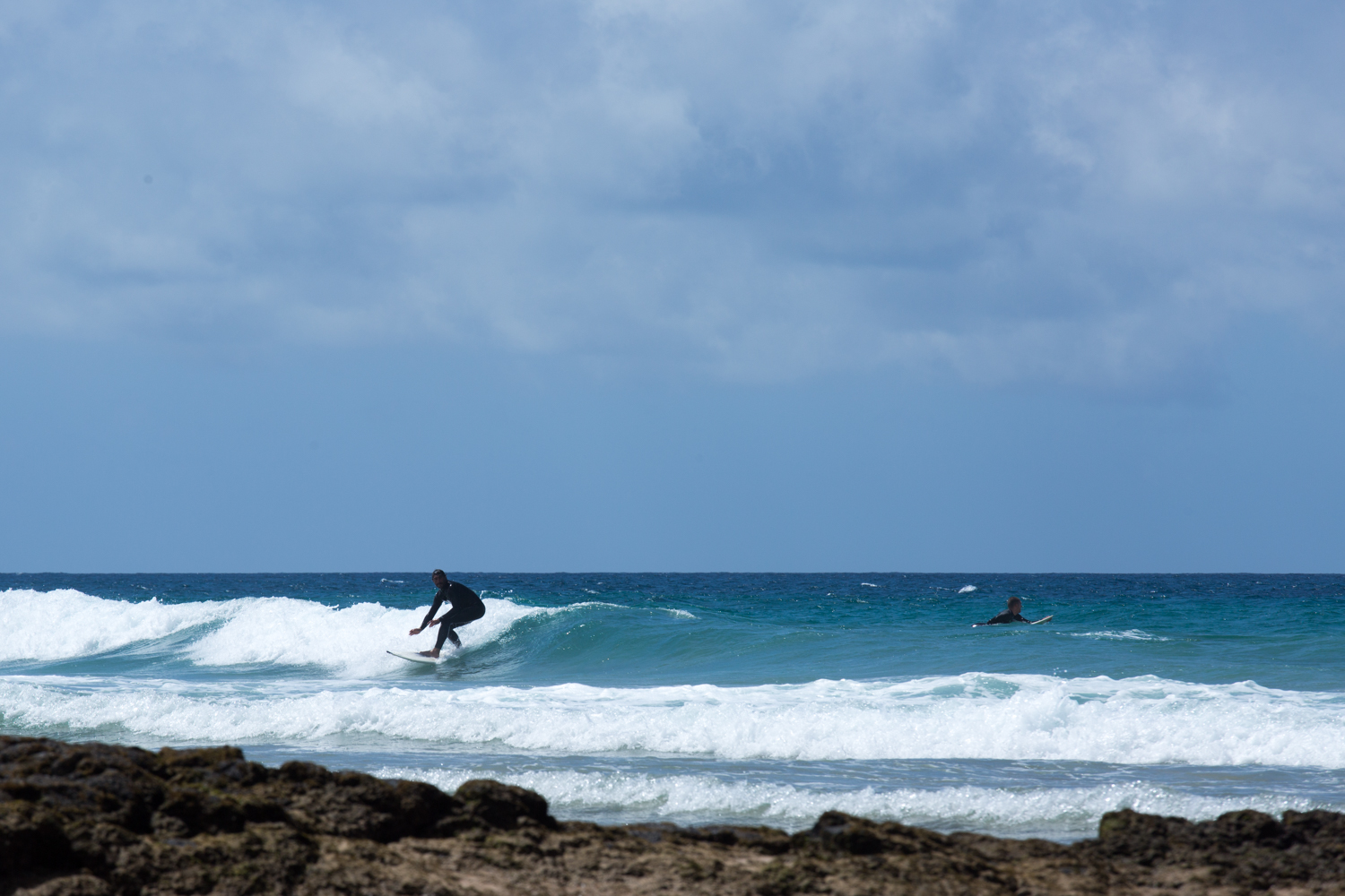 Surfer riding a wave at El Cotillo, Fuerteventura