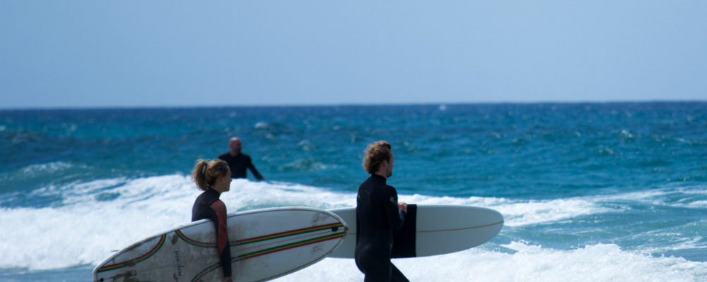 Two-surfers-heading-out-to-catch-a-wave