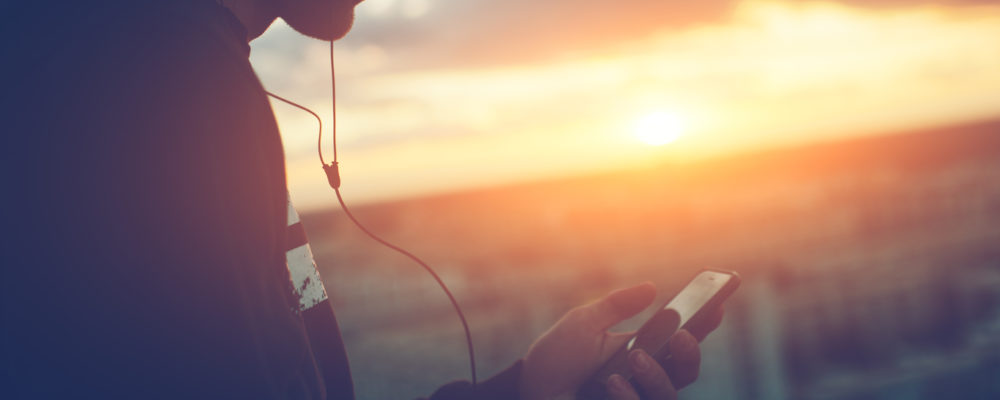 Man listening to the power of meditation on his phone