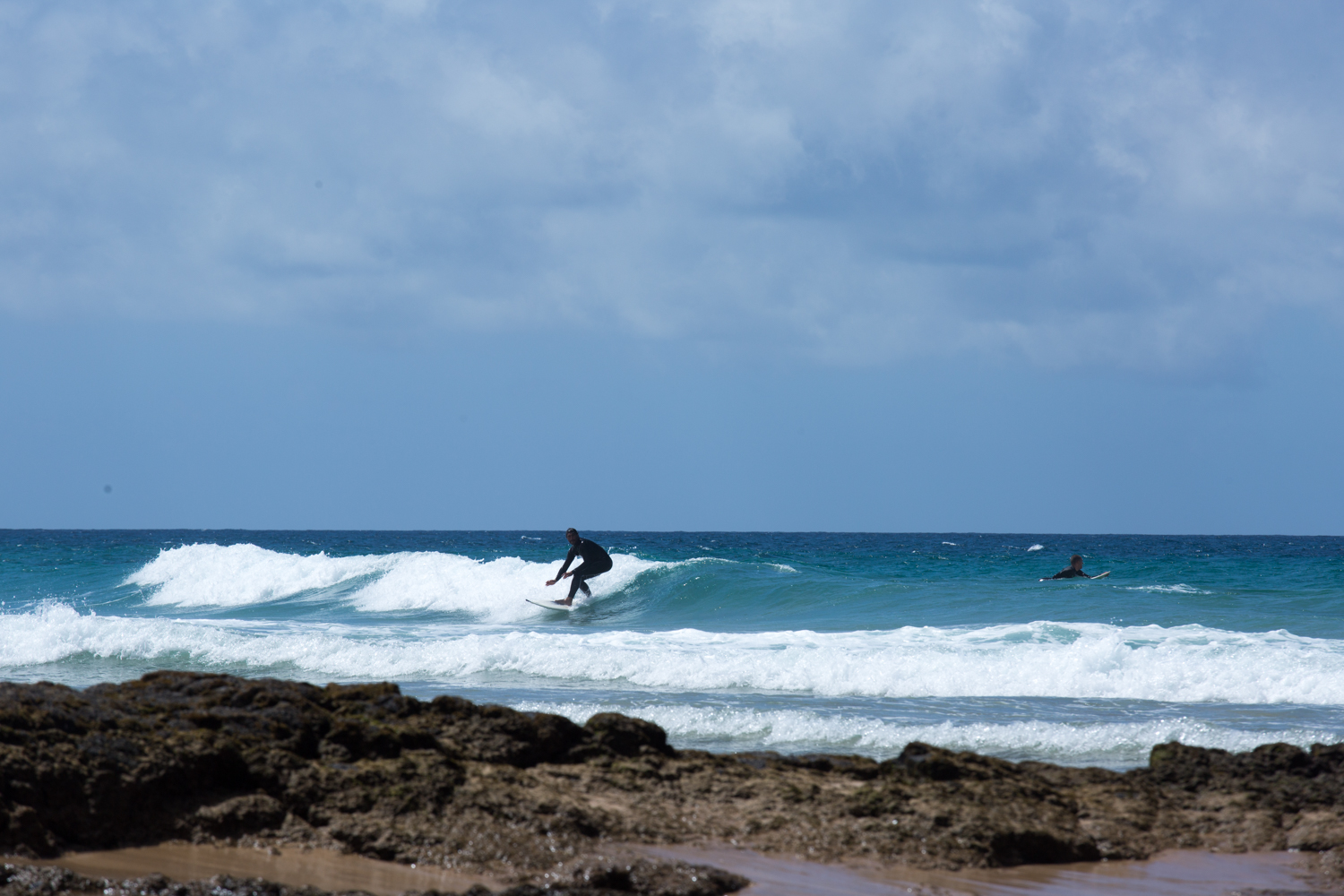 surfer riding a wave at el cotillo surf spot