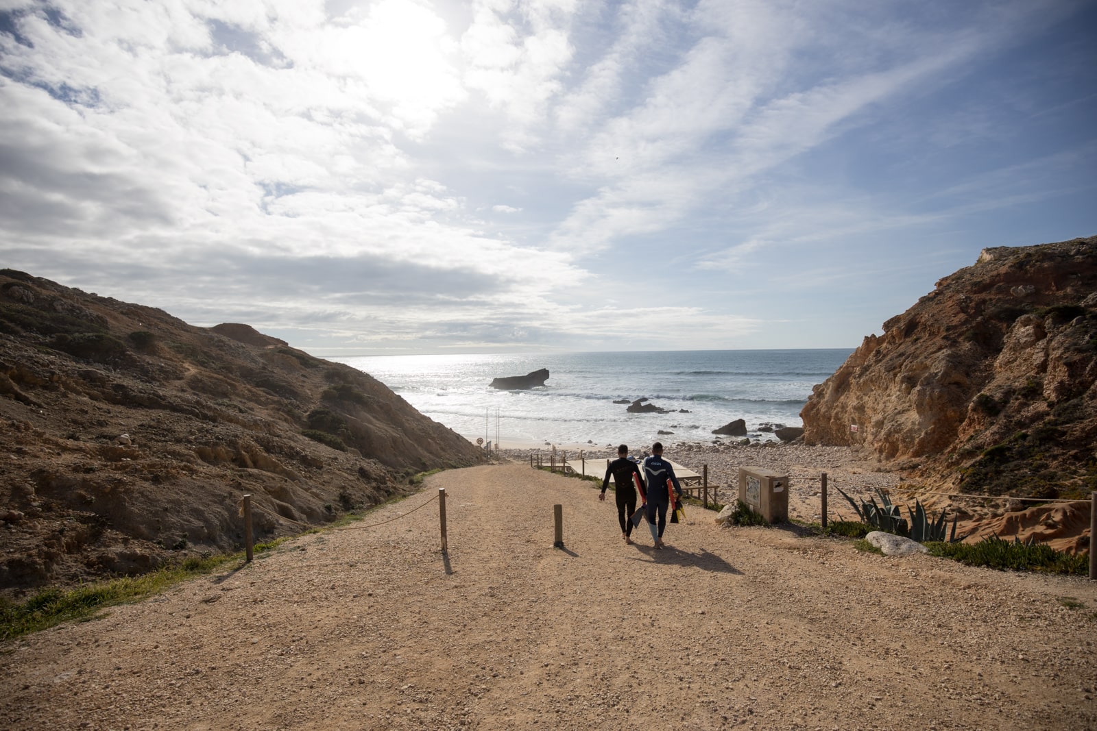 Bodyboarders heading to Tonel Beach in Sagres