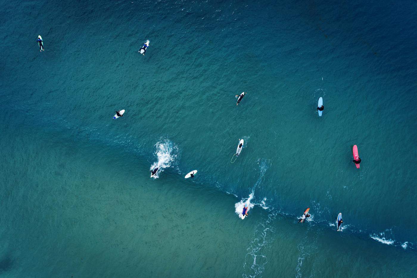 surfing line up catching a wave