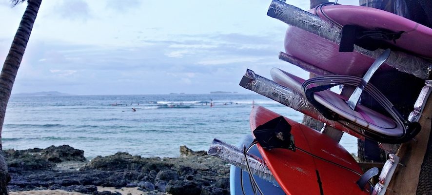 Surfboard rack with soft top surfboards on the beach