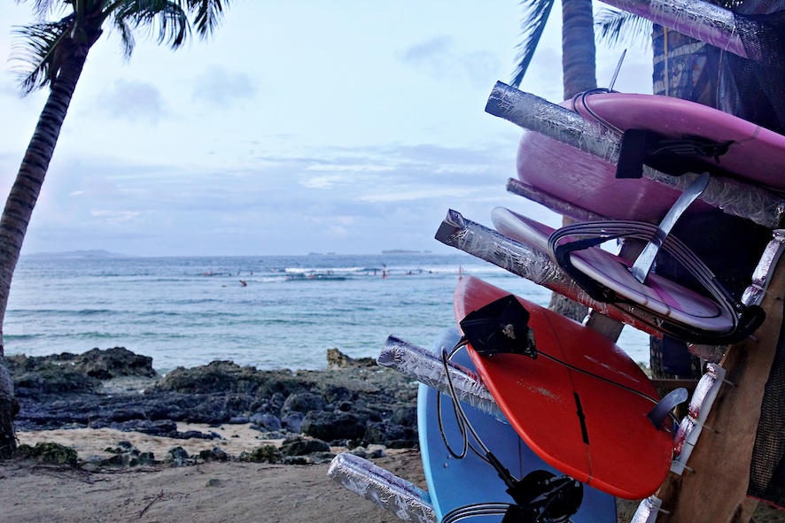 Surfboard rack with soft top surfboards on the beach