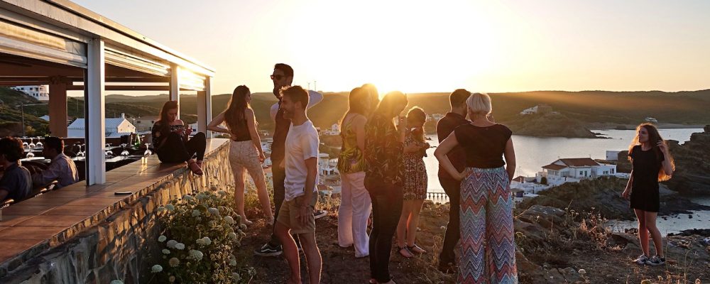 group of friends talking and watching the sunset