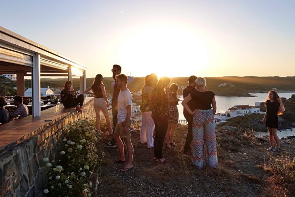 group of friends talking and watching the sunset