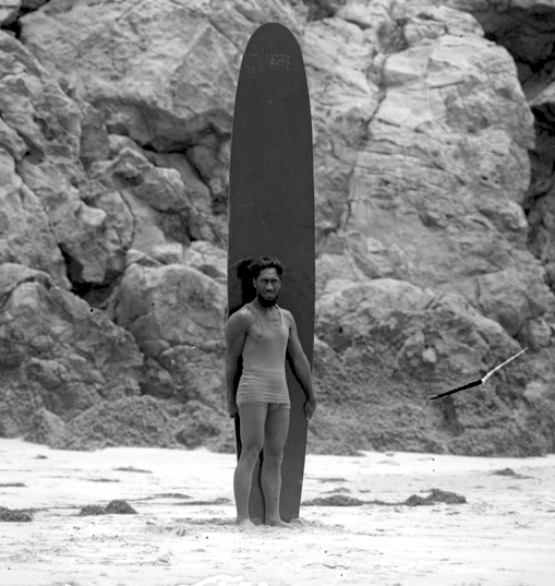 Duke Kahanamoku with a long board in California 