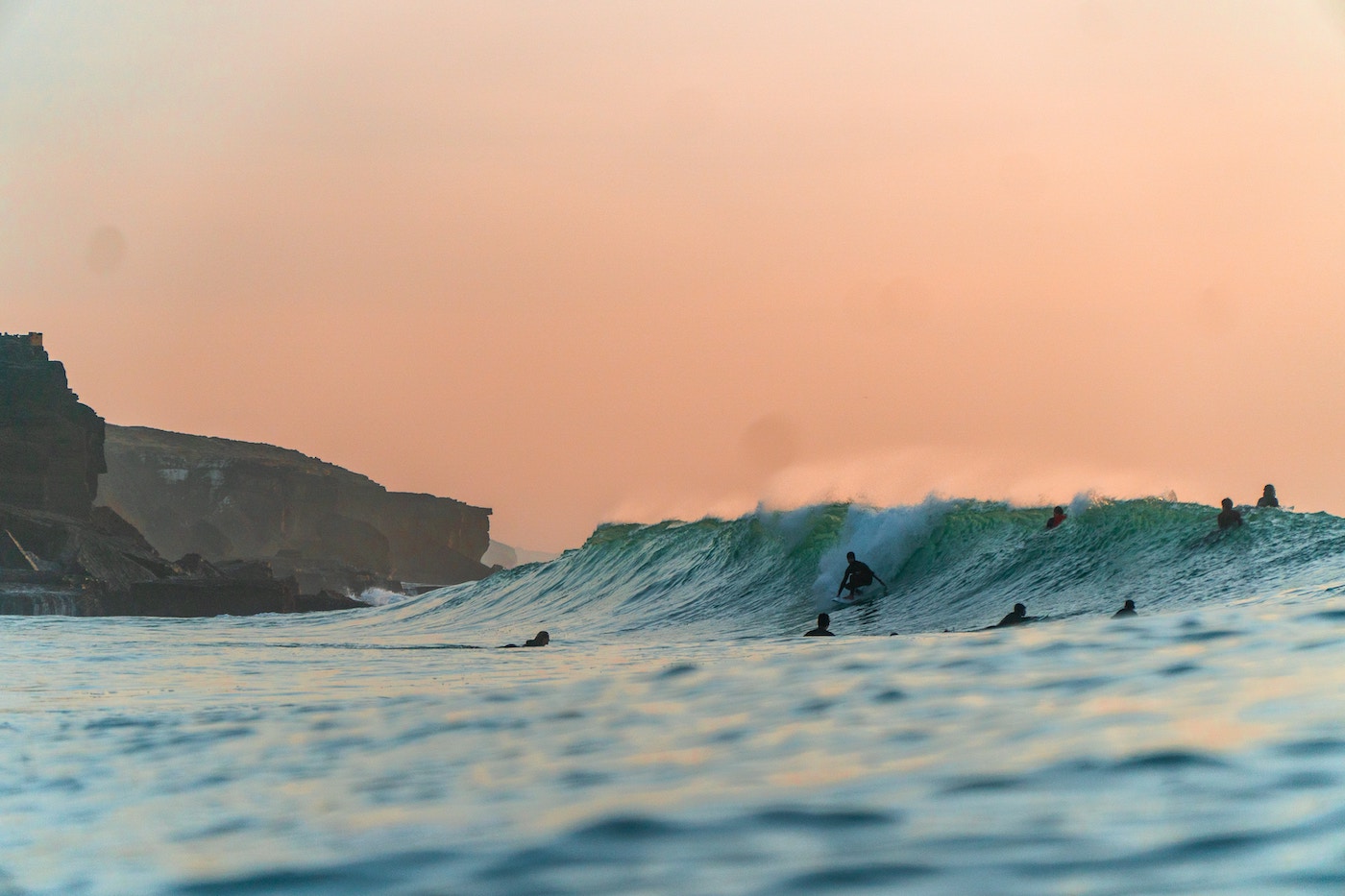 Surfers catching a wave in Ericeira