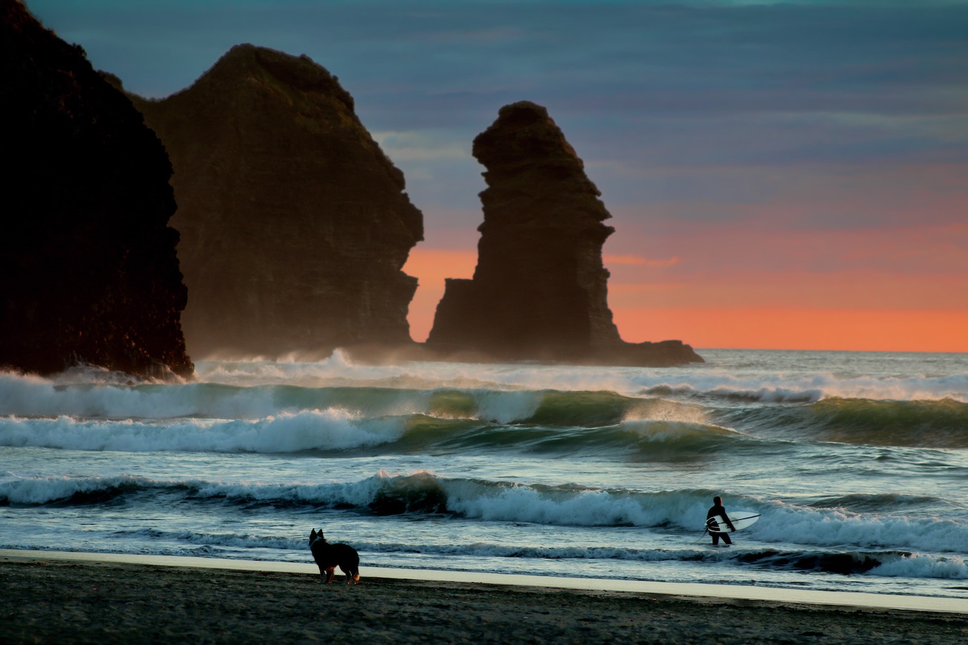 new zealand surf and surfer entering the water